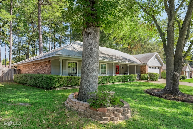 single story home with a front yard, a garage, and a porch