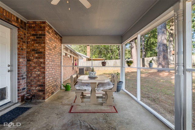 unfurnished sunroom with ceiling fan