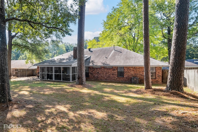 rear view of property with a sunroom