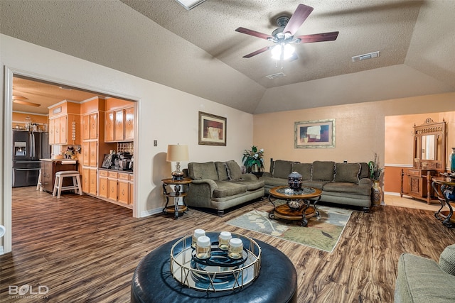 living room with a textured ceiling, lofted ceiling, dark hardwood / wood-style floors, and ceiling fan