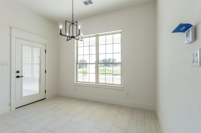 unfurnished dining area with a wealth of natural light and an inviting chandelier