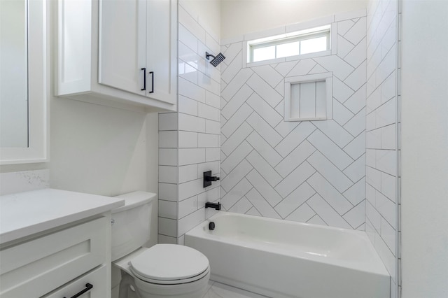 full bathroom with toilet, vanity, and tiled shower / bath