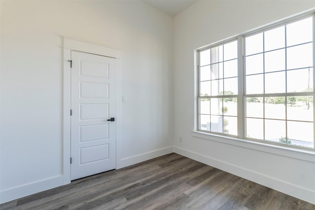 unfurnished room with dark hardwood / wood-style floors