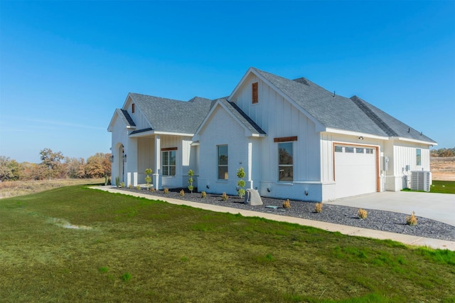 modern farmhouse style home with a garage, a front yard, and central AC