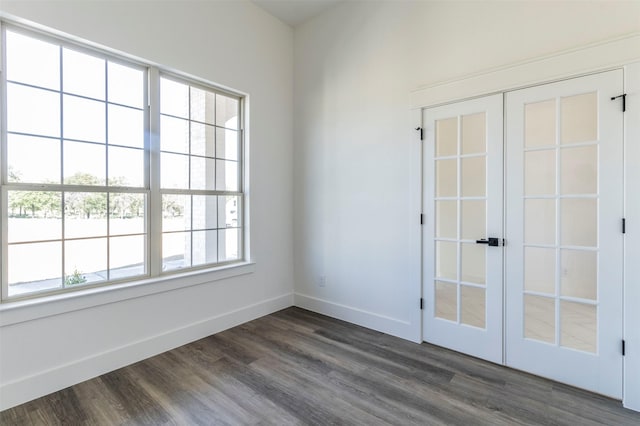 spare room with french doors and dark wood-type flooring