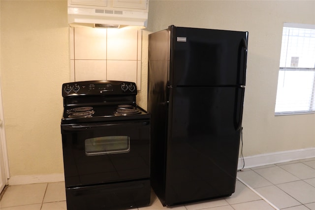 kitchen featuring black appliances, light tile patterned floors, and ventilation hood