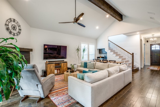 living room featuring beamed ceiling, ceiling fan with notable chandelier, dark wood-type flooring, and a healthy amount of sunlight