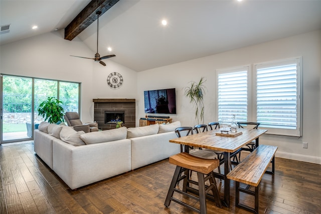 living room featuring a fireplace, beam ceiling, dark wood-type flooring, and ceiling fan