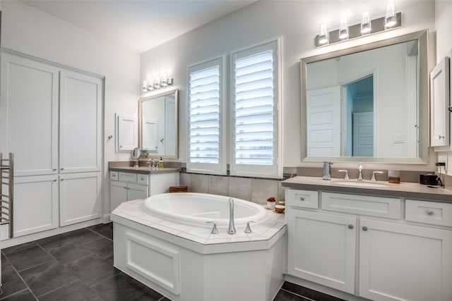 bathroom featuring vanity, a tub to relax in, and tile patterned flooring