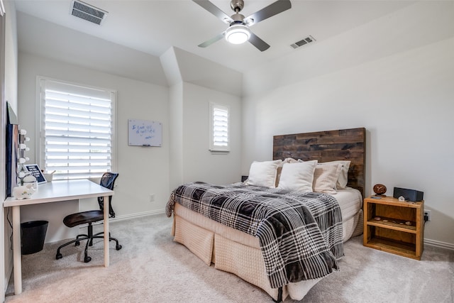 carpeted bedroom with multiple windows and ceiling fan