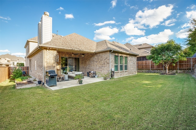 rear view of house with a patio area and a yard