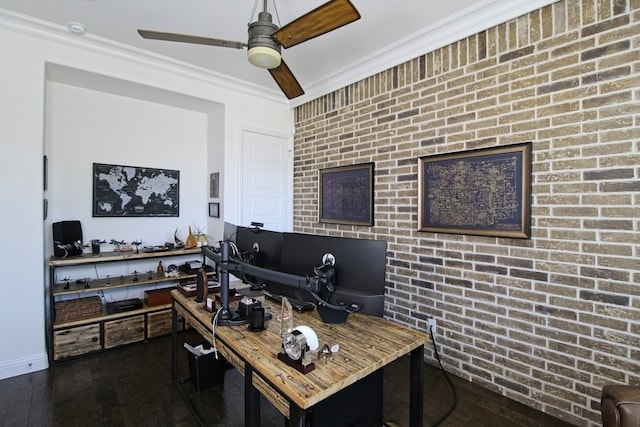 office space with crown molding, dark hardwood / wood-style flooring, ceiling fan, and brick wall