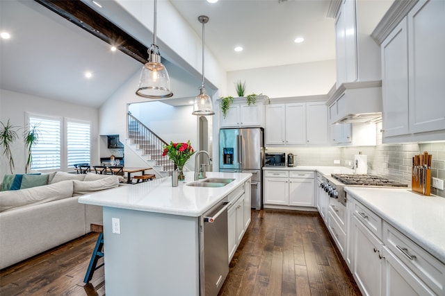 kitchen featuring appliances with stainless steel finishes, hanging light fixtures, white cabinets, dark hardwood / wood-style floors, and sink