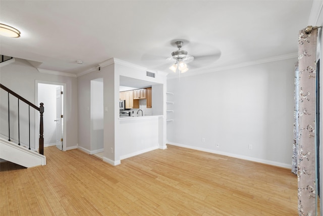 unfurnished living room with ceiling fan, light wood-type flooring, crown molding, and sink