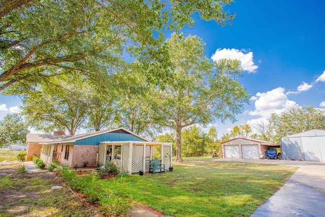 view of yard featuring an outdoor structure, a garage, and a porch