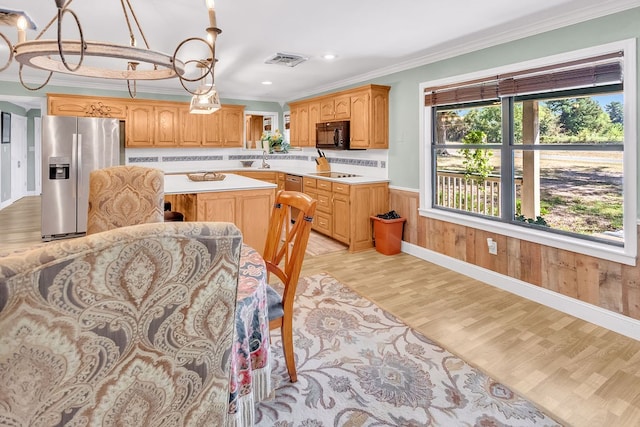 kitchen with light hardwood / wood-style floors, wood walls, crown molding, a center island, and stainless steel refrigerator with ice dispenser