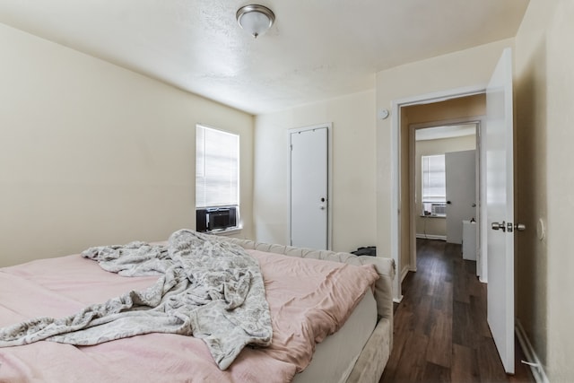 bedroom featuring cooling unit and dark hardwood / wood-style floors