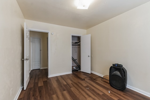 unfurnished bedroom featuring a closet and dark hardwood / wood-style flooring