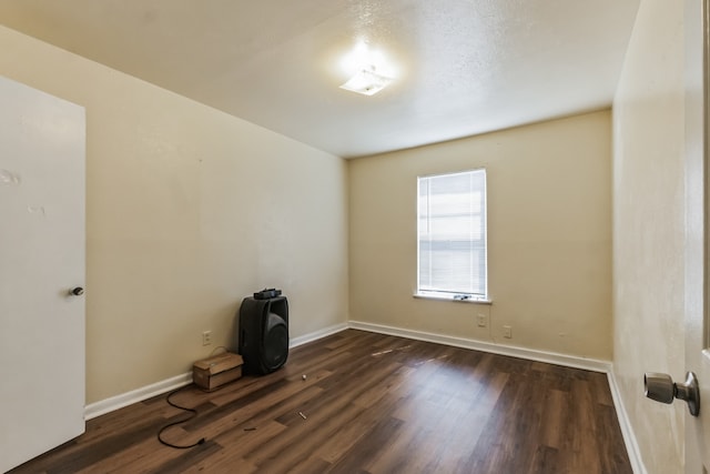 unfurnished room featuring dark wood-type flooring