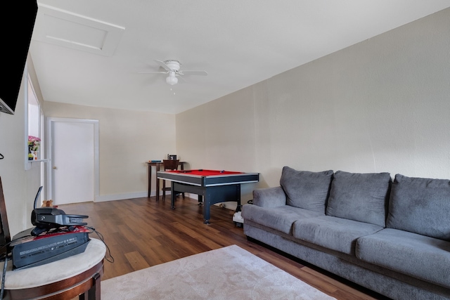 living room with dark hardwood / wood-style flooring and ceiling fan