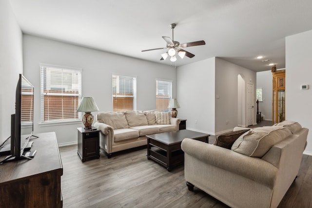 living room with wood-type flooring and ceiling fan