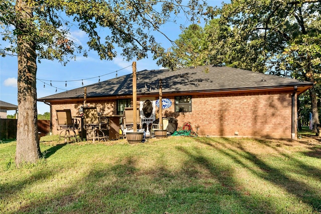 rear view of house featuring a yard