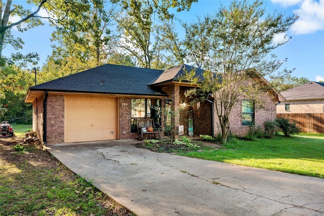 single story home featuring a garage and a front lawn