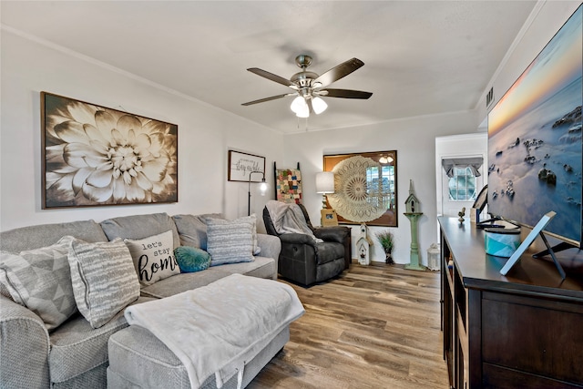 living room featuring ceiling fan, crown molding, and hardwood / wood-style floors