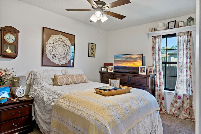 bedroom with a textured ceiling, carpet, and ceiling fan