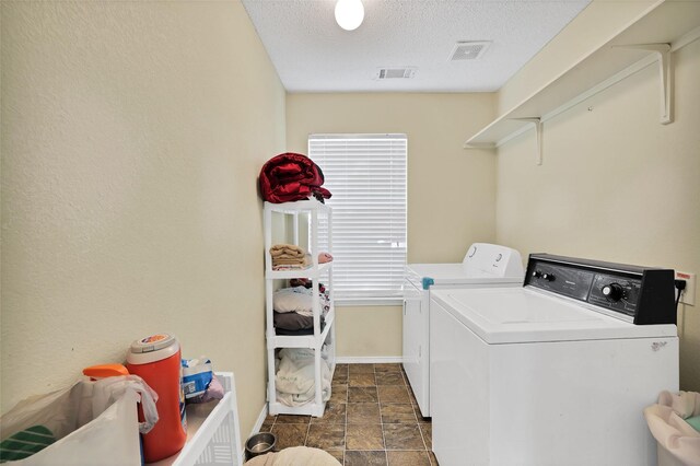 laundry area with a textured ceiling and washer and clothes dryer