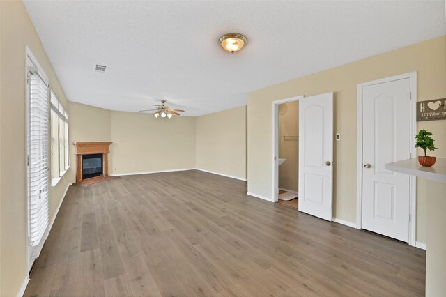 unfurnished living room featuring wood-type flooring and ceiling fan