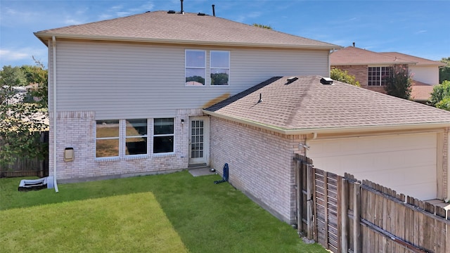 rear view of house with a lawn