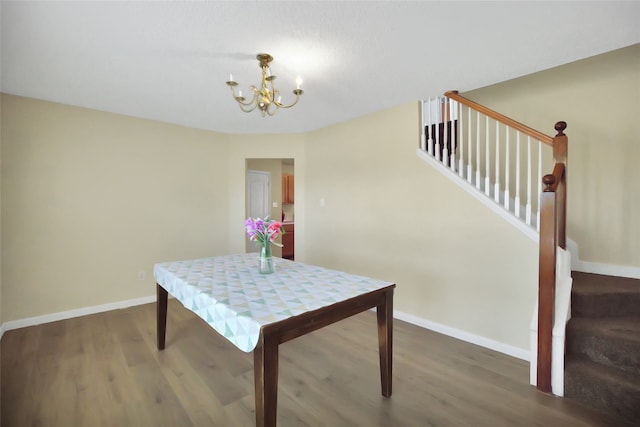 dining space featuring an inviting chandelier and dark hardwood / wood-style flooring