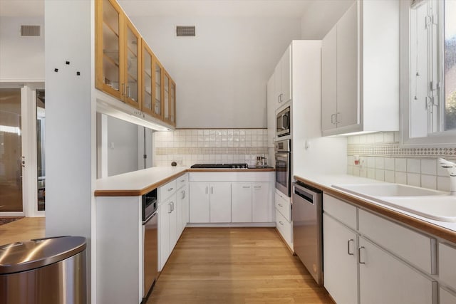 kitchen featuring tasteful backsplash, appliances with stainless steel finishes, sink, and white cabinets