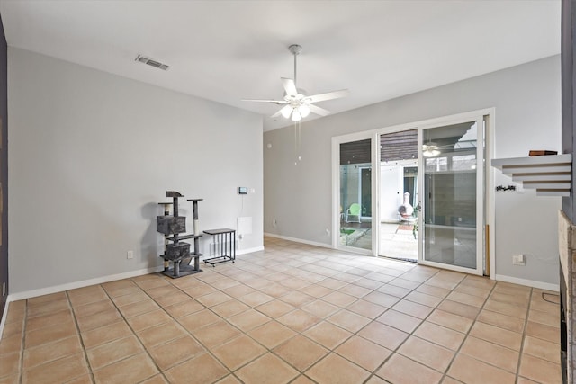 tiled spare room with ceiling fan