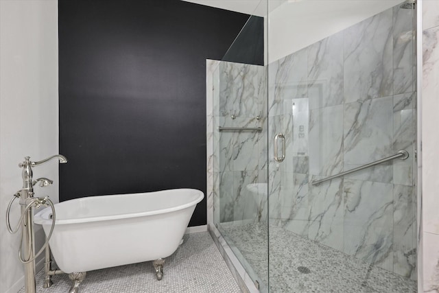 bathroom featuring tile patterned floors and separate shower and tub