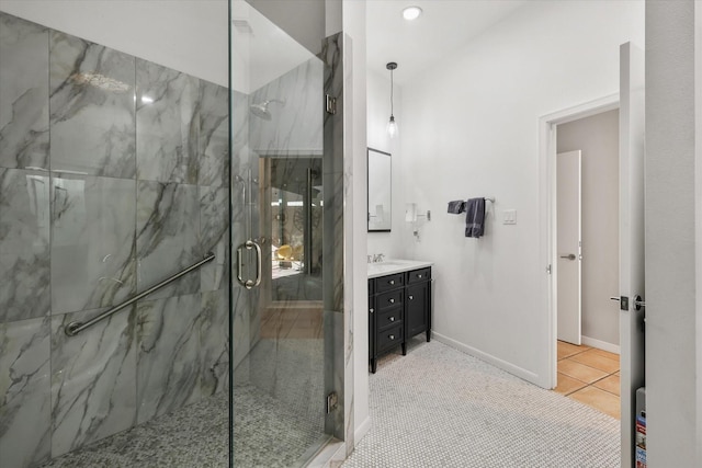 bathroom featuring a shower with door, vanity, and tile patterned floors