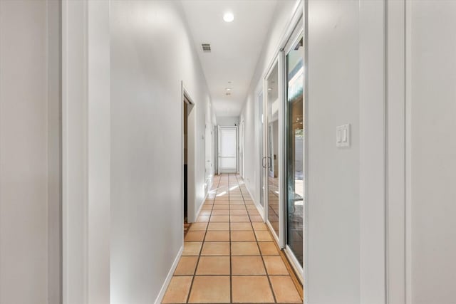 hall with light tile patterned floors