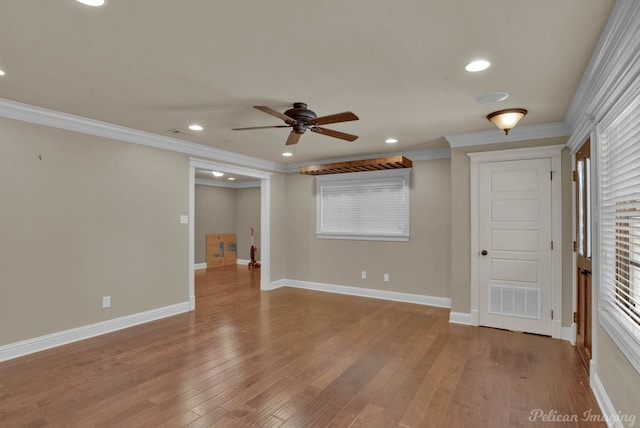 empty room featuring ceiling fan, ornamental molding, and light hardwood / wood-style floors