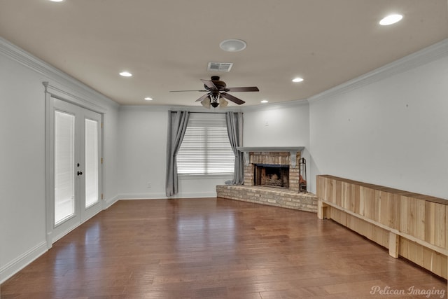 unfurnished living room with ceiling fan, a fireplace, crown molding, and wood-type flooring