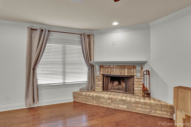 living room with ornamental molding, a brick fireplace, and hardwood / wood-style flooring