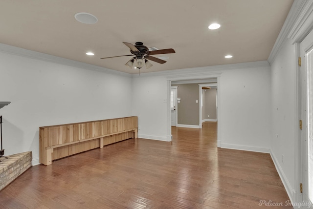 empty room featuring ceiling fan, hardwood / wood-style flooring, and ornamental molding