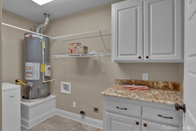 clothes washing area featuring gas water heater, hookup for an electric dryer, cabinets, light tile patterned floors, and hookup for a washing machine