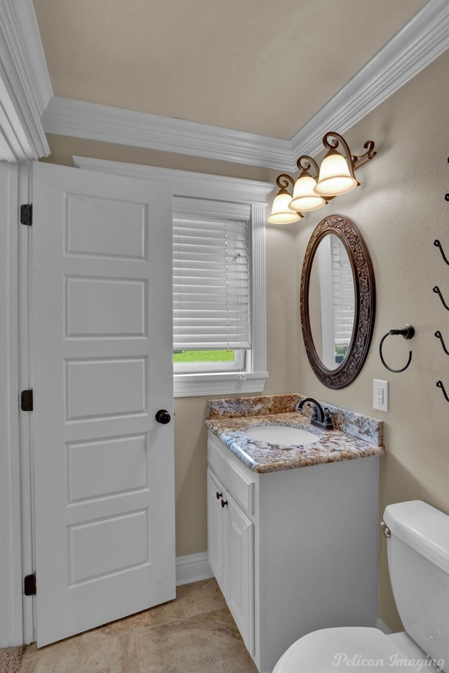 bathroom with crown molding, vanity, and toilet