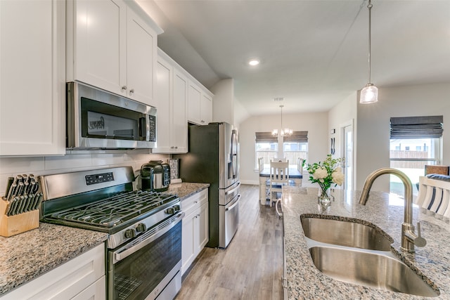 kitchen with sink, a chandelier, stainless steel appliances, and plenty of natural light