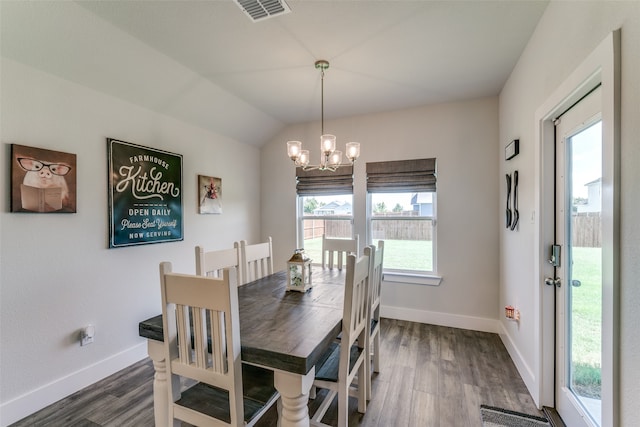 dining room featuring a notable chandelier, plenty of natural light, vaulted ceiling, and dark hardwood / wood-style floors