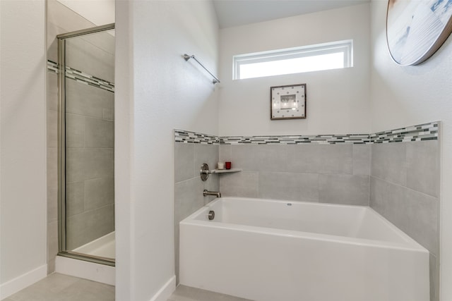 bathroom featuring separate shower and tub and tile patterned flooring