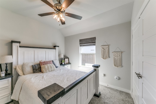 carpeted bedroom with ceiling fan and vaulted ceiling