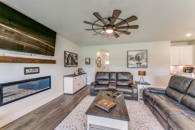 living room with ceiling fan and dark hardwood / wood-style floors