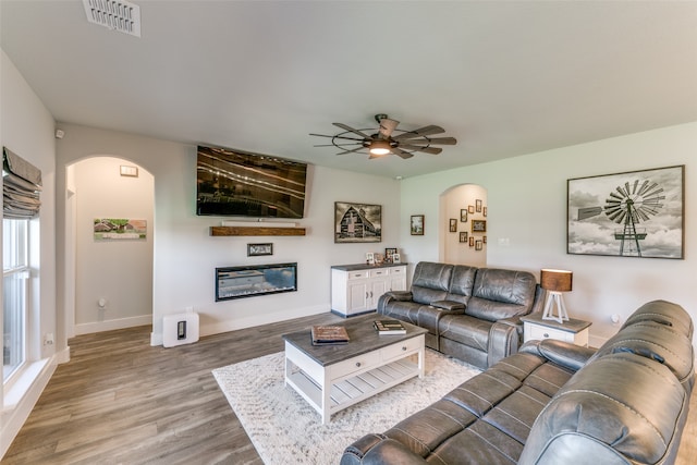 living room featuring ceiling fan and hardwood / wood-style flooring